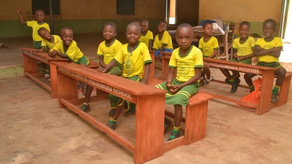Students sitting on the newly donated desks