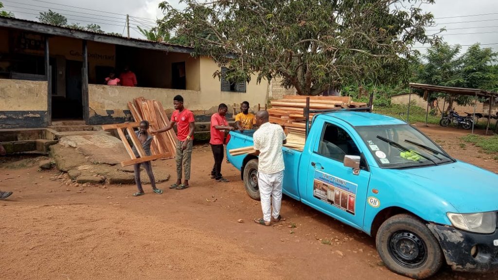 Bed Frames being offlaoded from a truck fior the Faith Needy Children's Home initiative