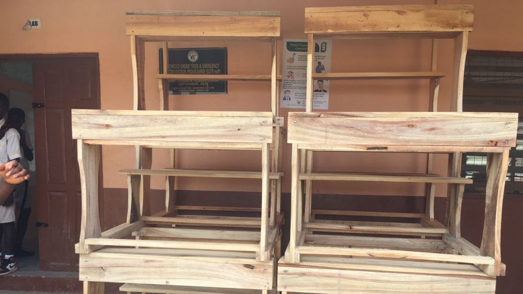 The image shows some newly supplied school desks. Supporting the appeal for desks for Adonkwanta