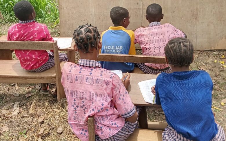 Image 1 of children attending classes outdoor. Peculiar People's Academy School Renovation Project