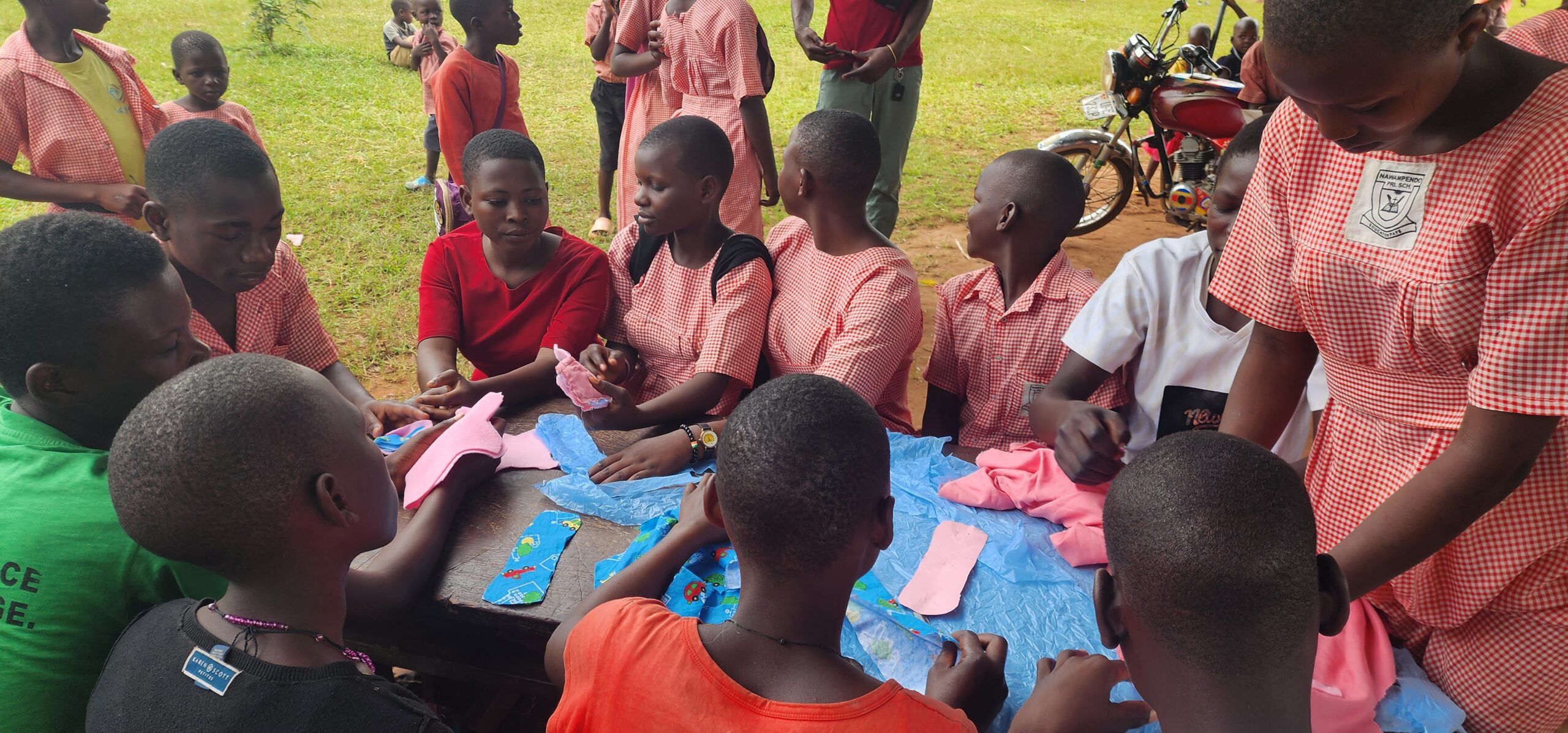 Young girls gathered around learning how to sew